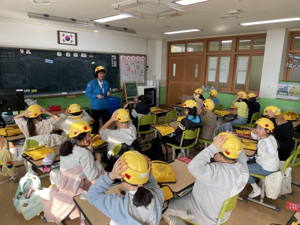 울진 죽변초등학교 학생들이 어린이용 경안전모를 착용하고 안전 교육을 받고 있다./사진=현대건설